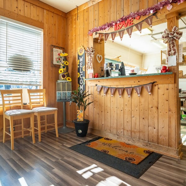 Cozy interior of Pete's Pizza with wooden walls, bar stools, and festive decorations.