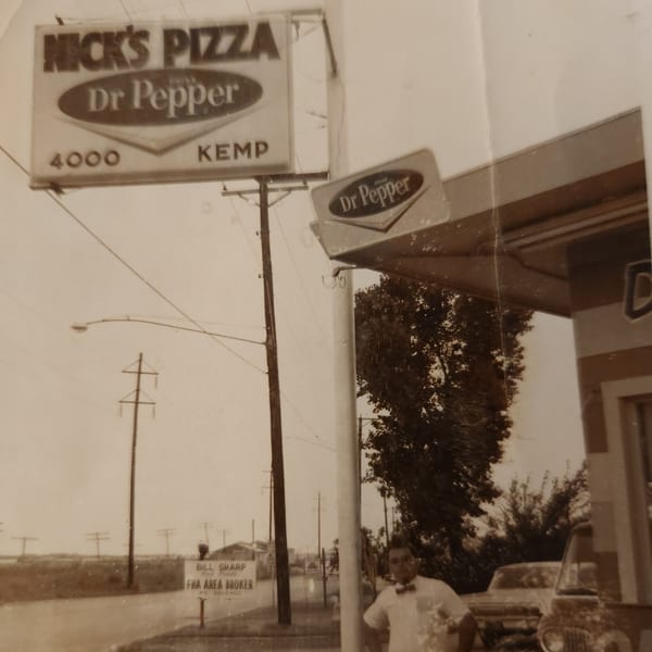 Vintage photo of Nick's Pizza sign with Dr Pepper logo, a man, and cars on a street.